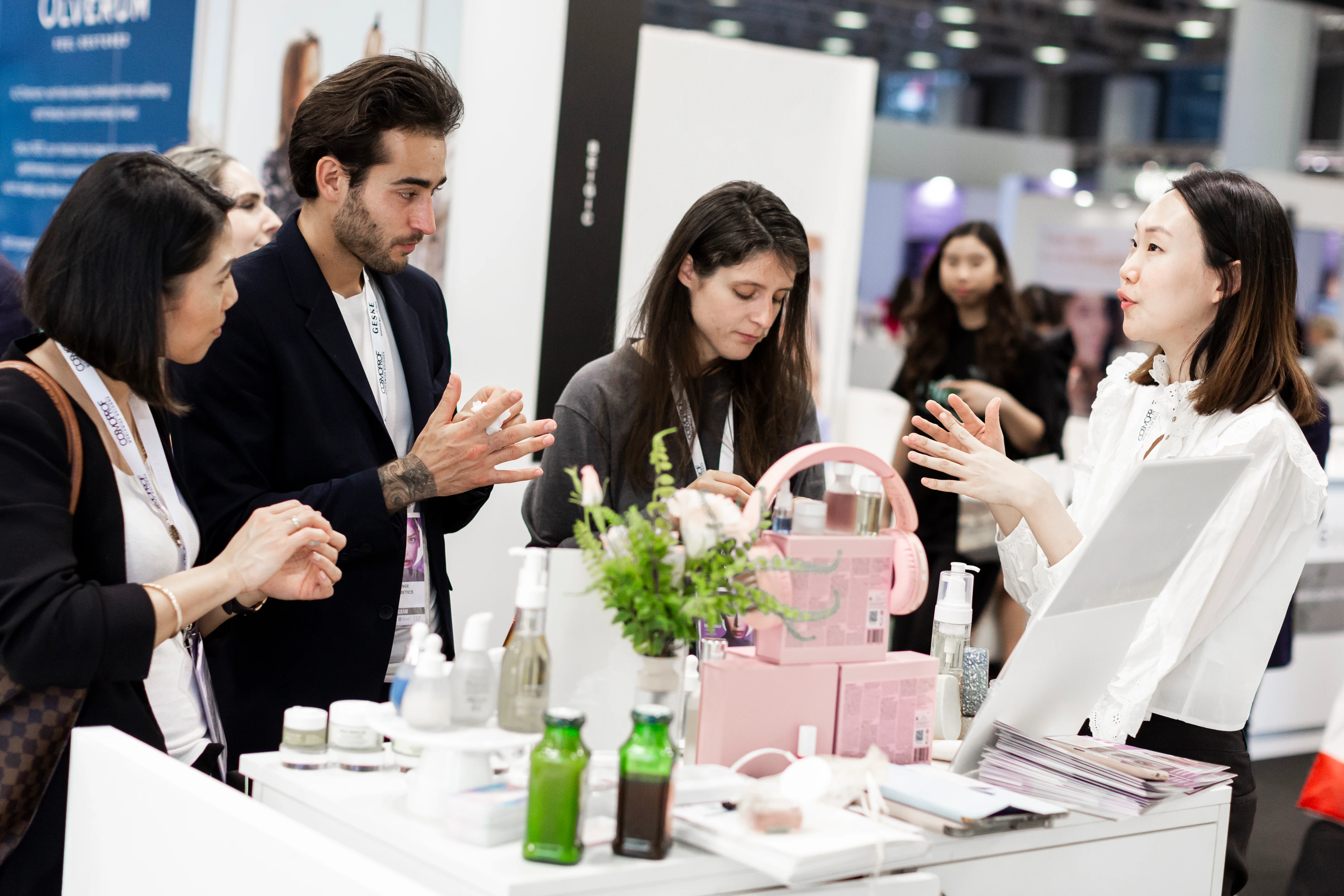 Beauty professionals discussing products and exhibition support at Cosmoprof Worldwide Bologna